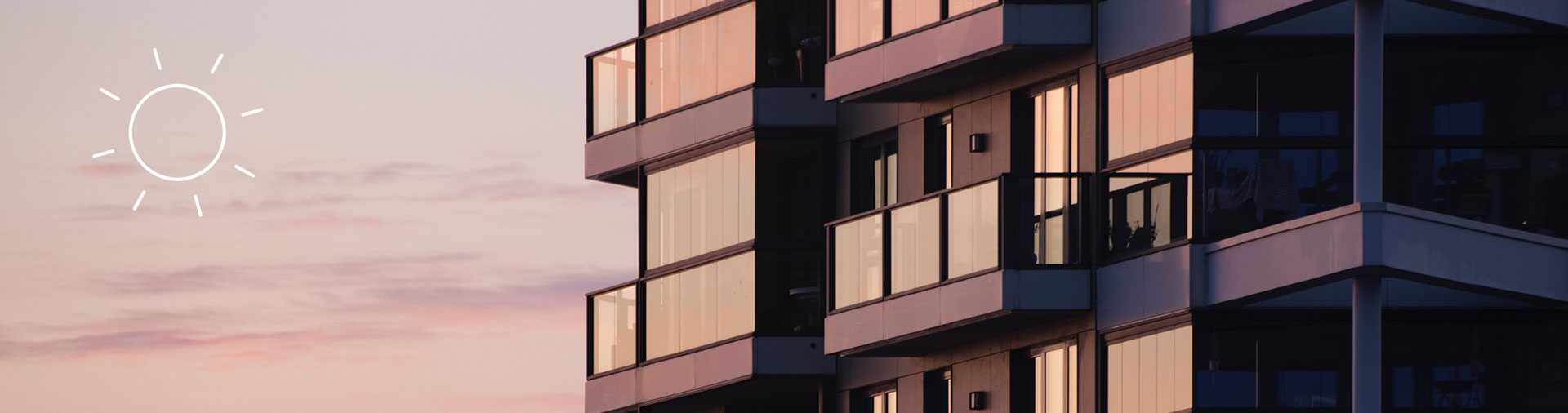 Ein modernes Wohnhaus am Abend, seitlich Balkons